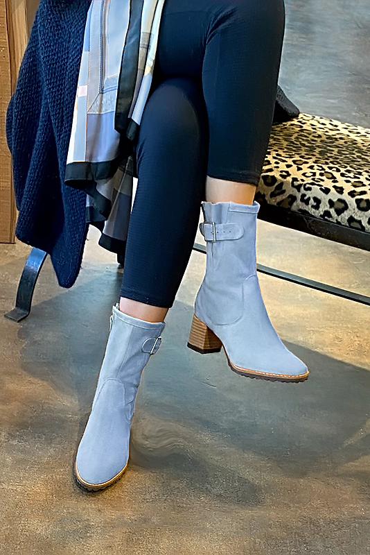 Sky blue women's ankle boots with buckles on the sides. Round toe. Medium block heels. Worn view - Florence KOOIJMAN
